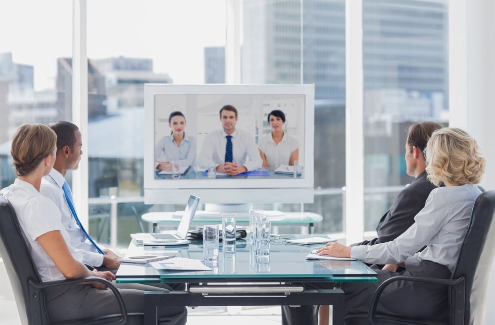 Business team having video conference with another business team in office Business team having video conference with another business team in office